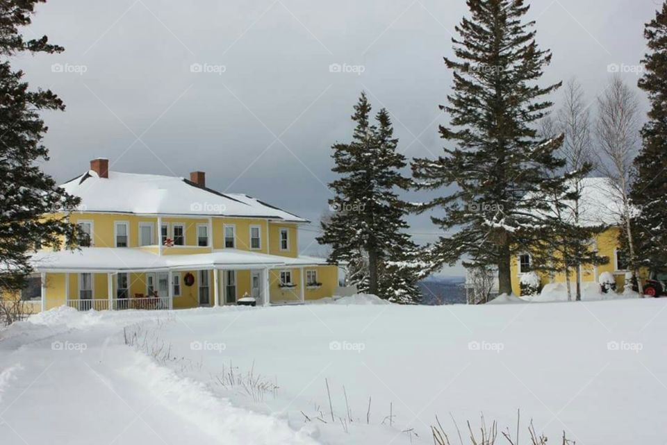 A beautiful house covered in snow.
