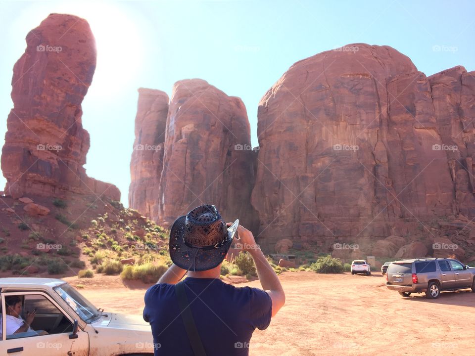 Cow boy take a photo of the monument valley 