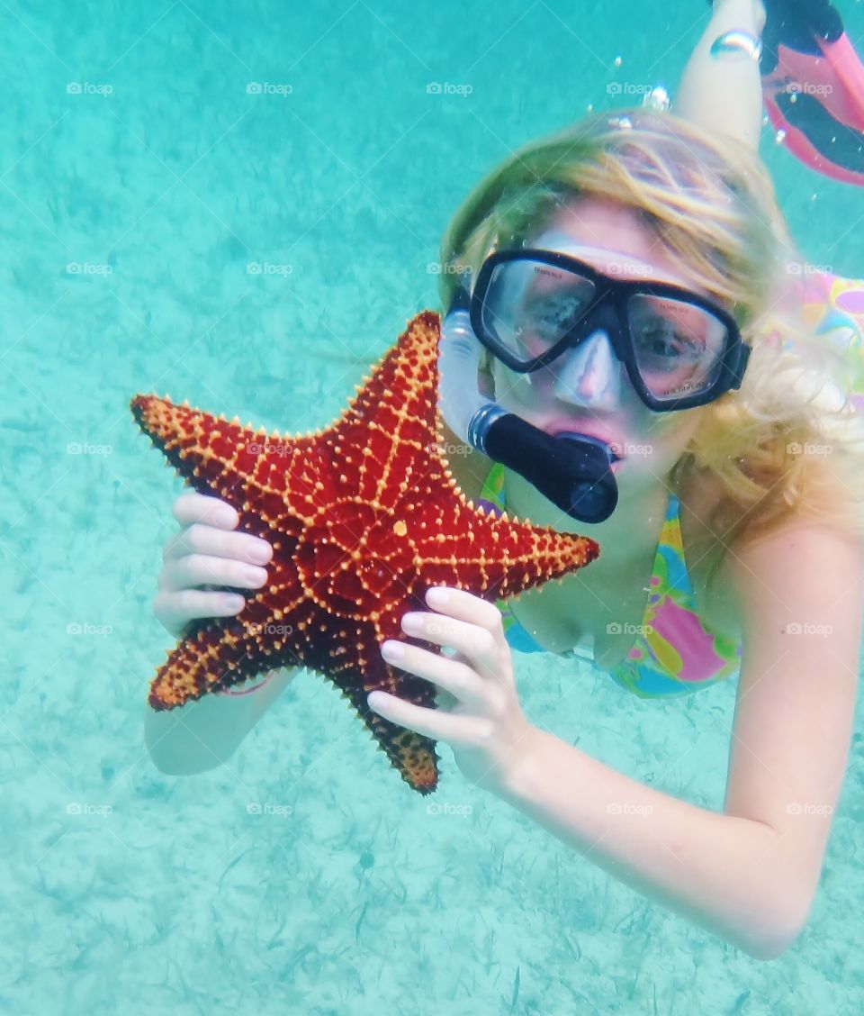 Woman was a starfish snorkeling underwater