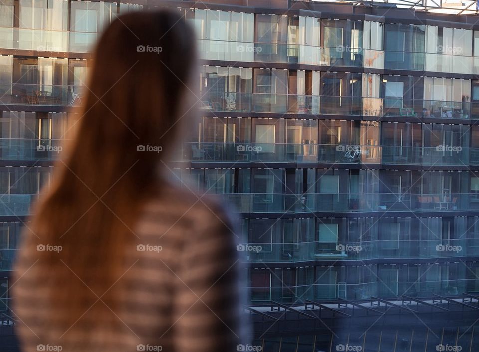 Girl watching the sunlight on the building