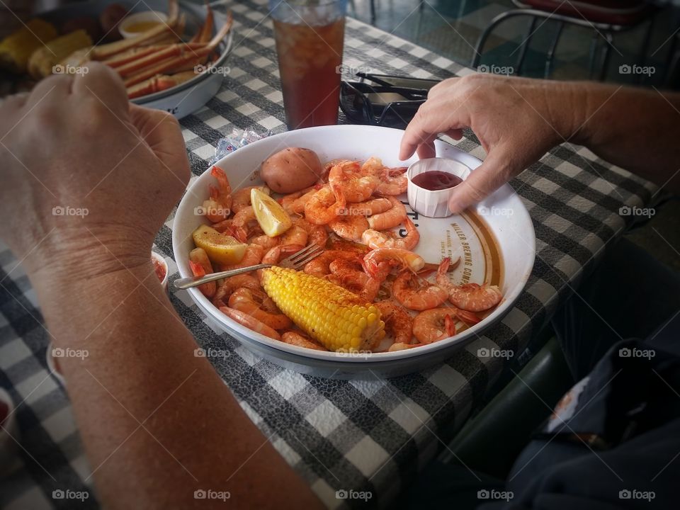 A traditional shrimp boil with corn and potatoes peel and eat