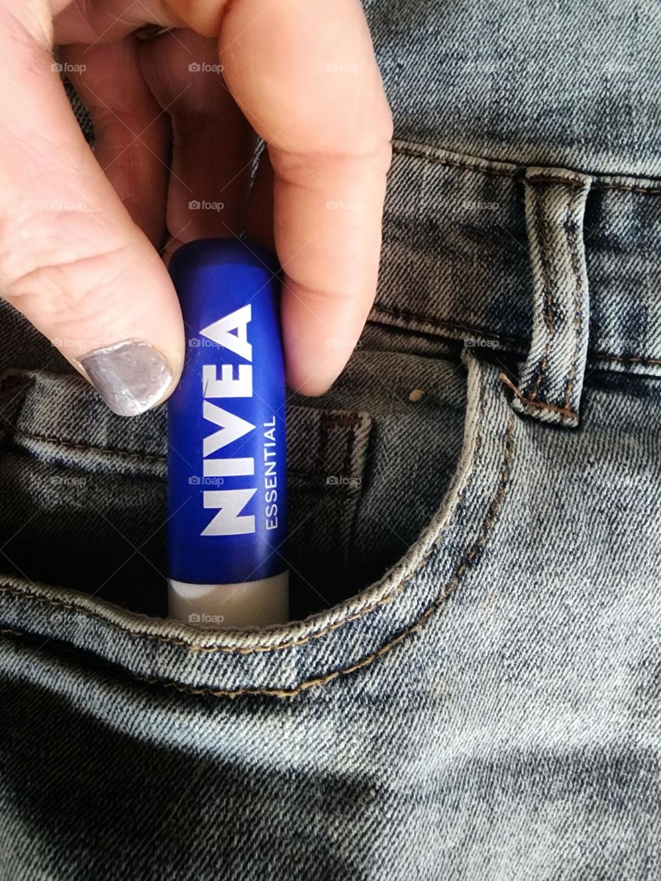 Grabbing my Nivea essentials lip balm from my pocket.