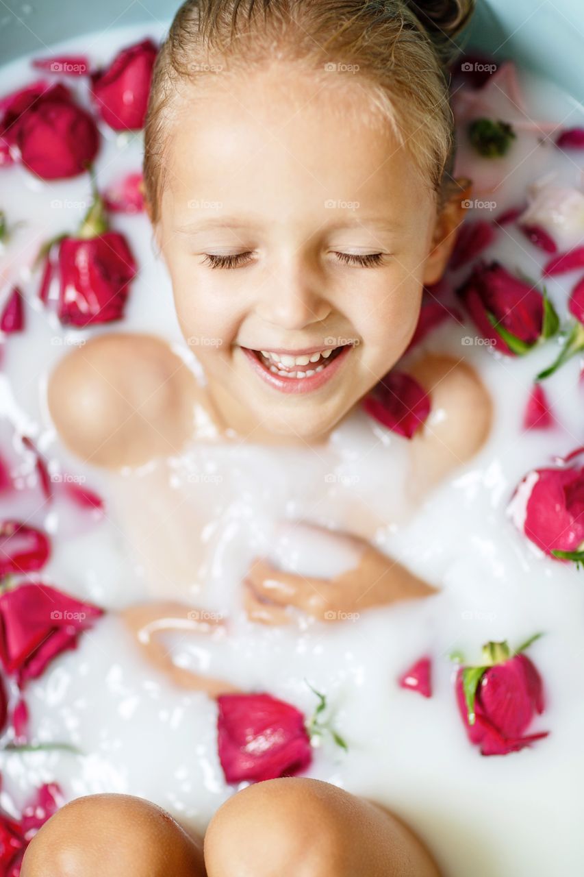 Portrait of happy little girl in bathroom 