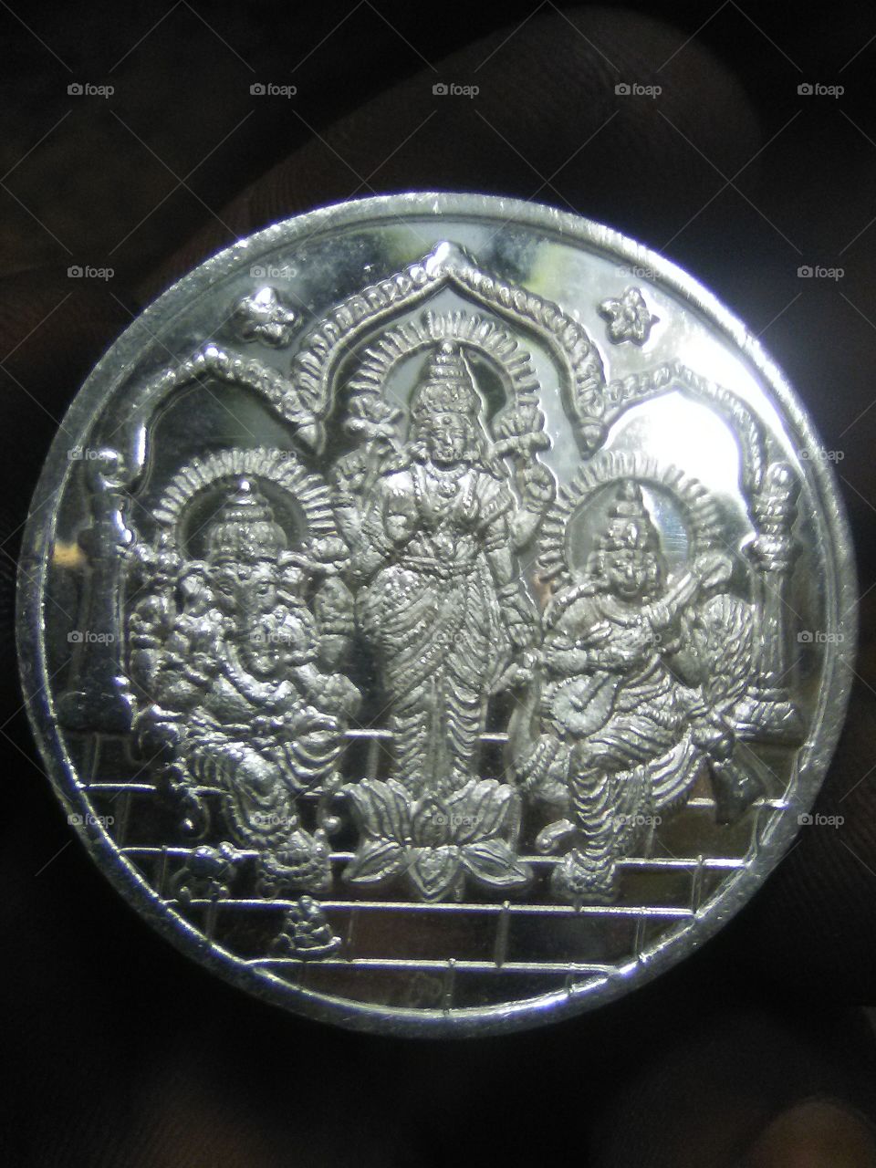 Close-up of silver coin against black background