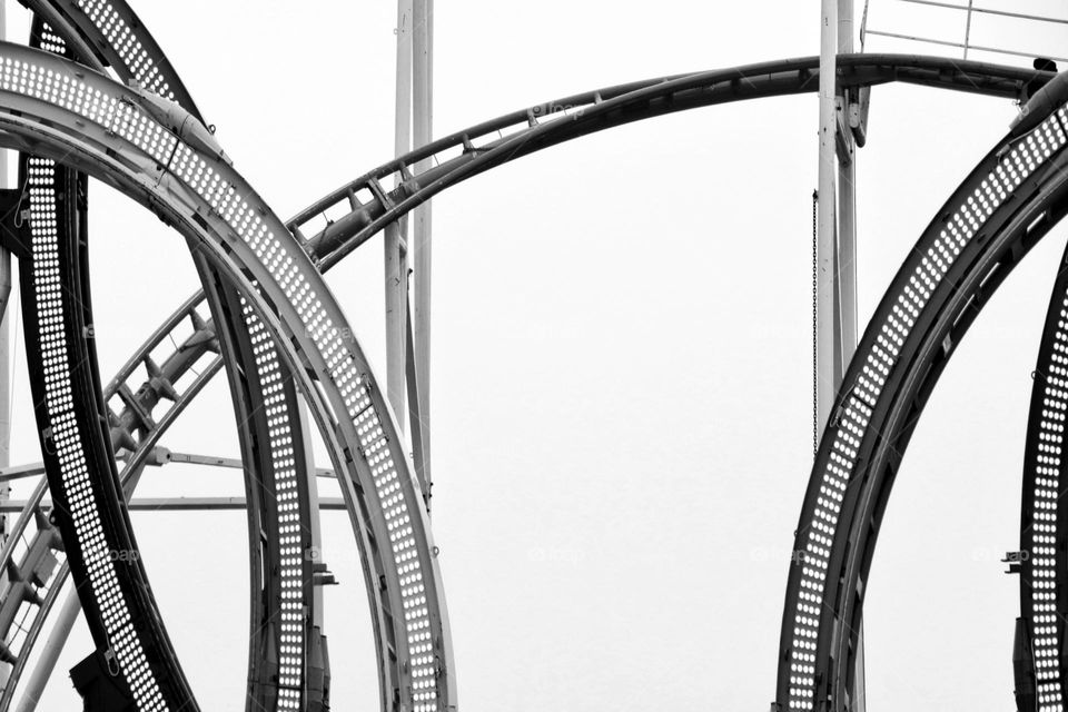 Minimalist detail shot of a roller coaster against a clear sky with an emphasis on patterns and lines