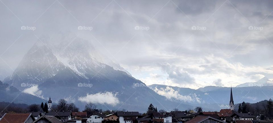 The Alps seen from the famous town of “Garmisch Partenkirchen” keep the mountaintops concealed in a high altitude fog. Just as the song says: This is what it’s like to be above the clouds. 2023. Hypnotic Productions