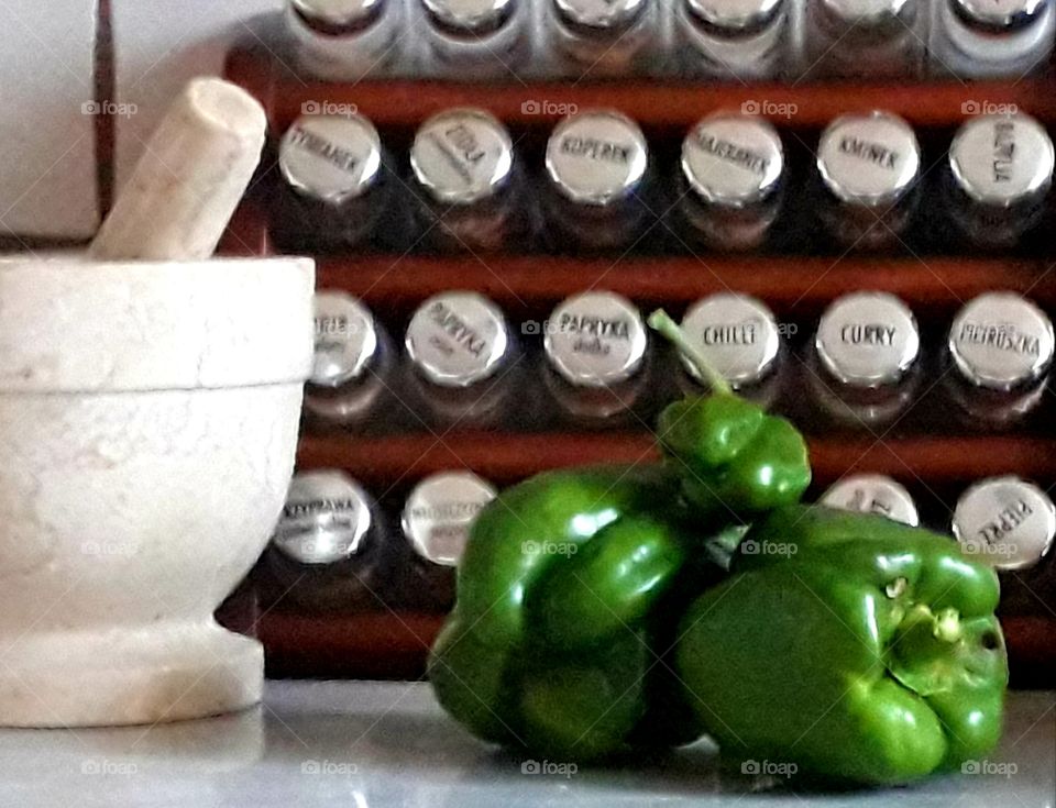 spices marble mortar and green peppers in the kitchen