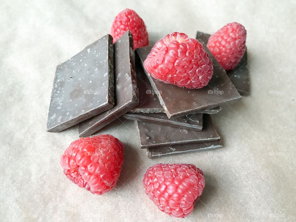 Pieces of chocolate and raspberries