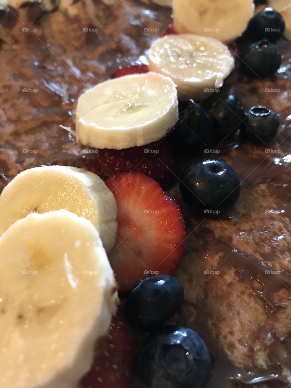 Crepe with banana, strawberry, and blueberries
