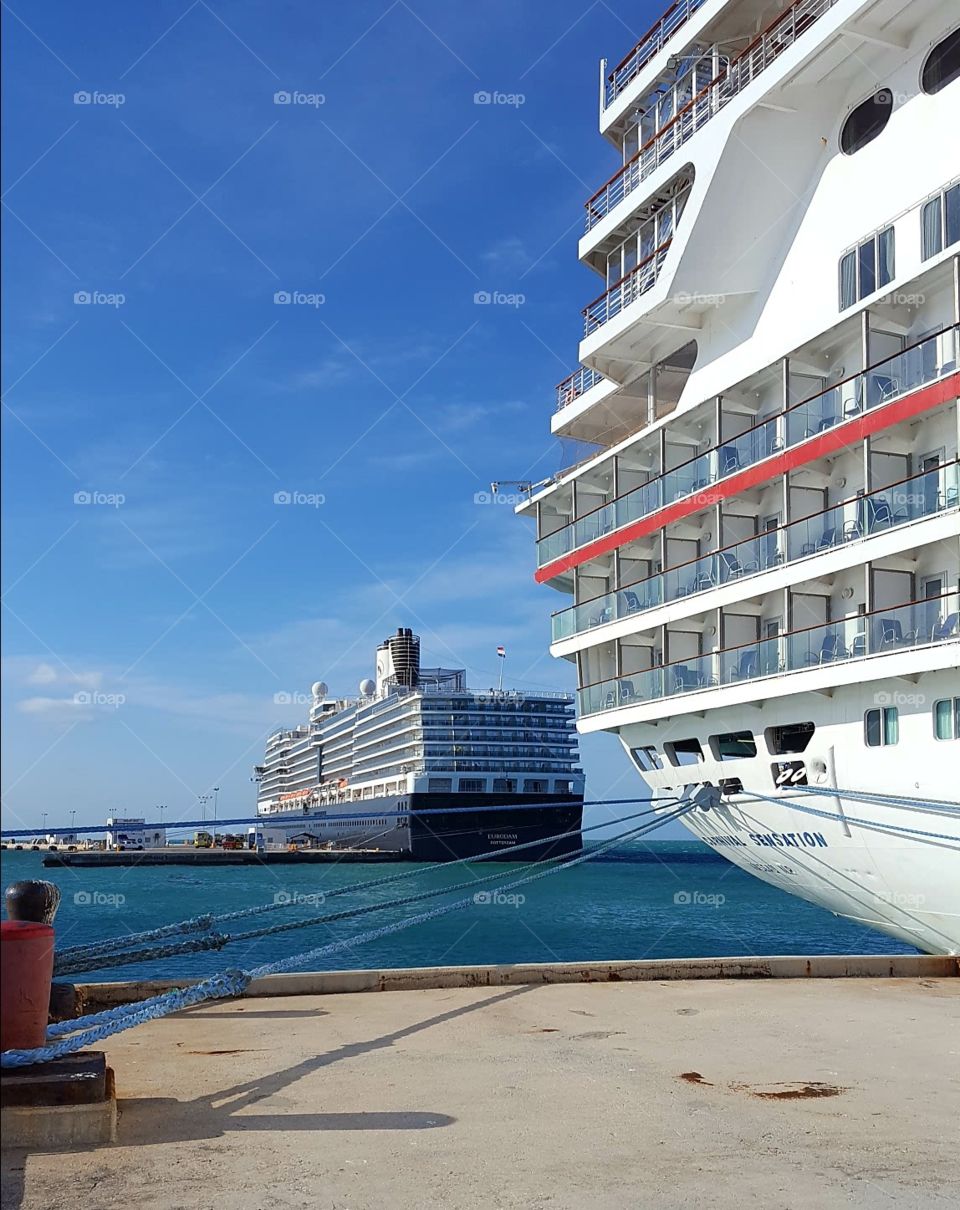 Large cruise ships in port with beautiful blue sky and deep blue water