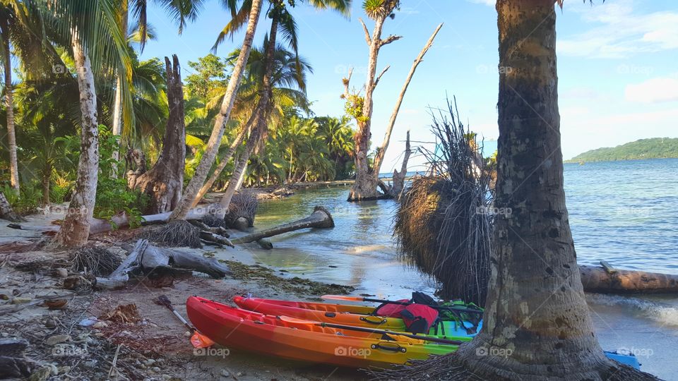 tropical beach in bocas del Toro with colourful kayaks on the shore