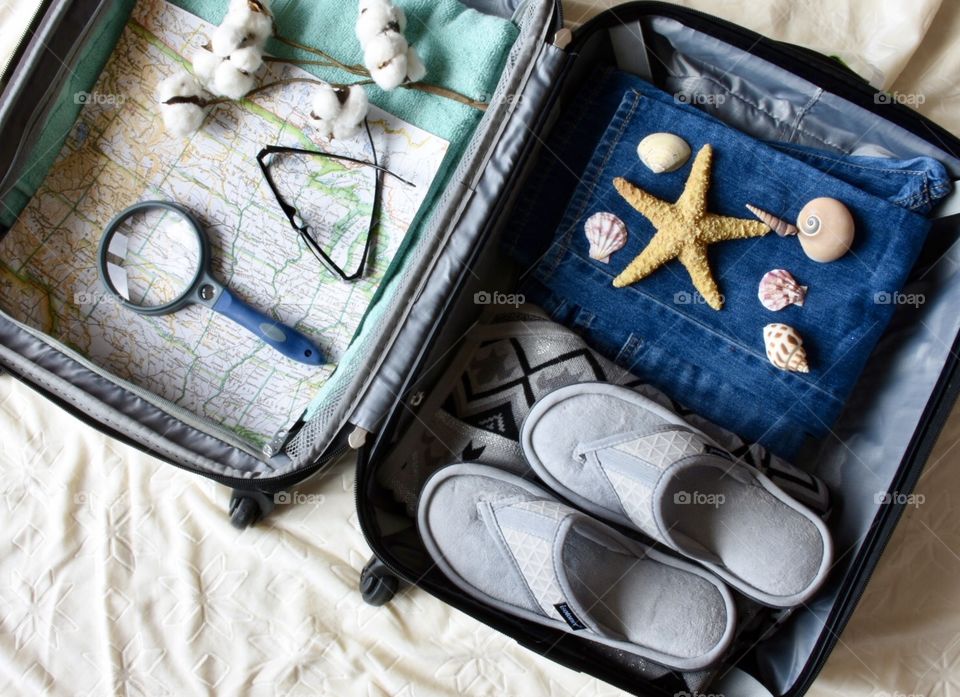 Travel, opened suitcase with things from vacation visible 