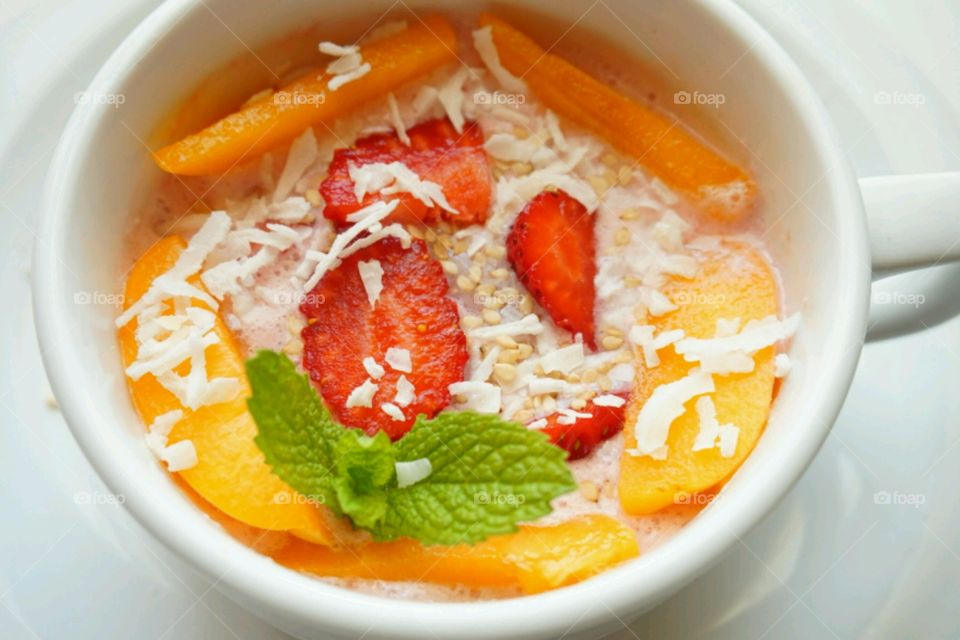 Strawberry and coconut with peach in bowl