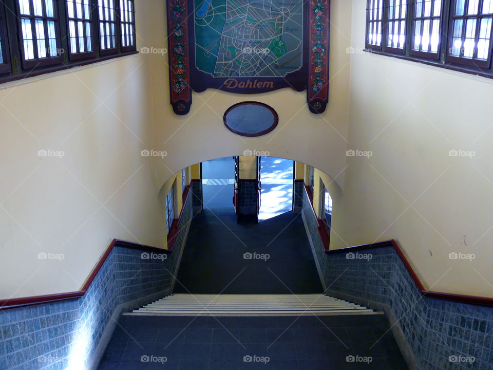 High angle view of staircase inside metro station Dahlem Dorf leading to gates.