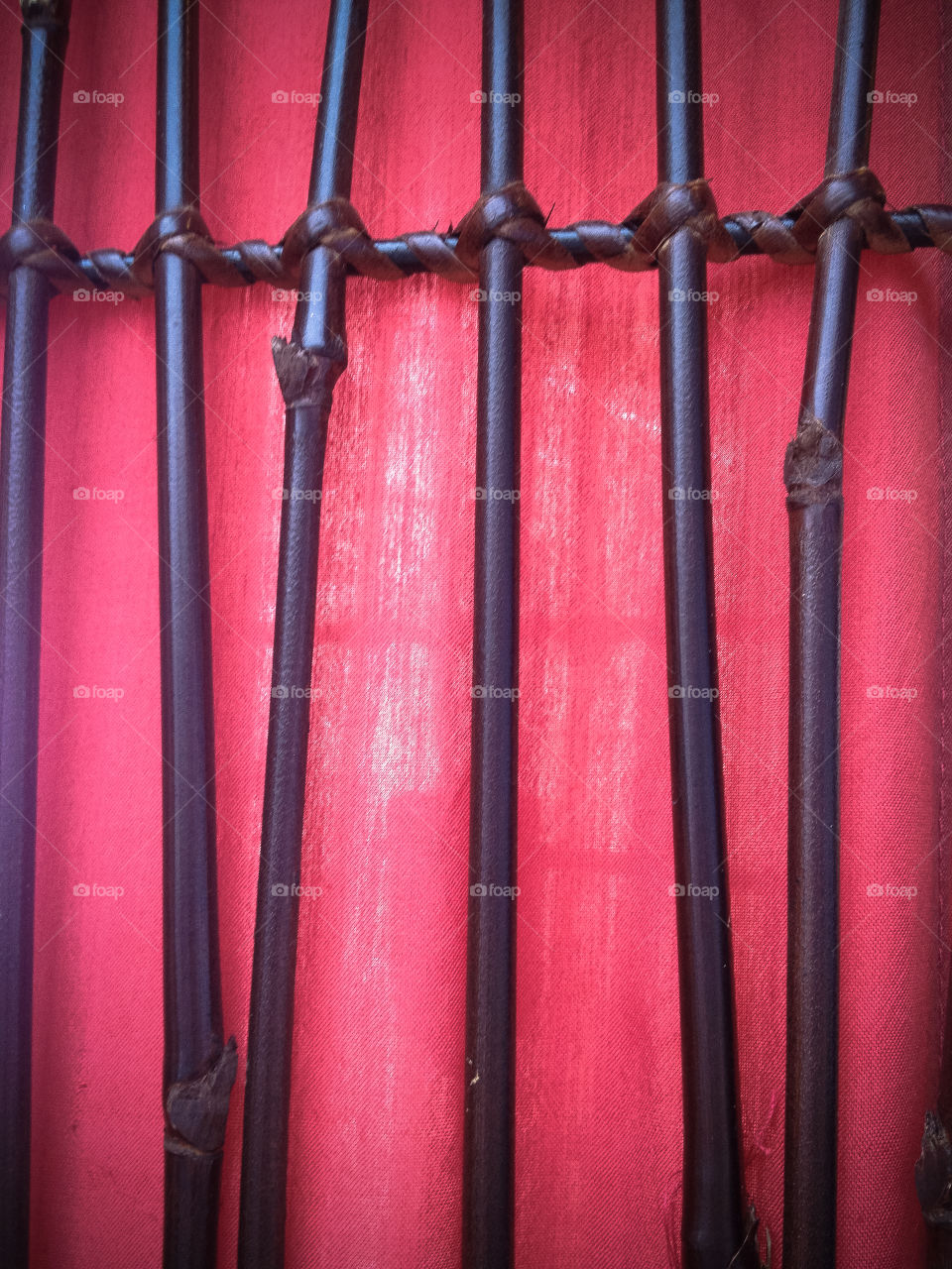 Bamboo fence with red background