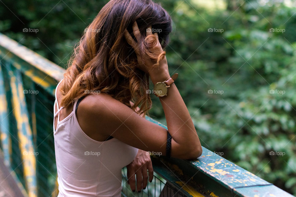 Rear view of a woman standing on bridge