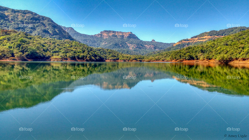 Mountain and blue sky reflecting in lake