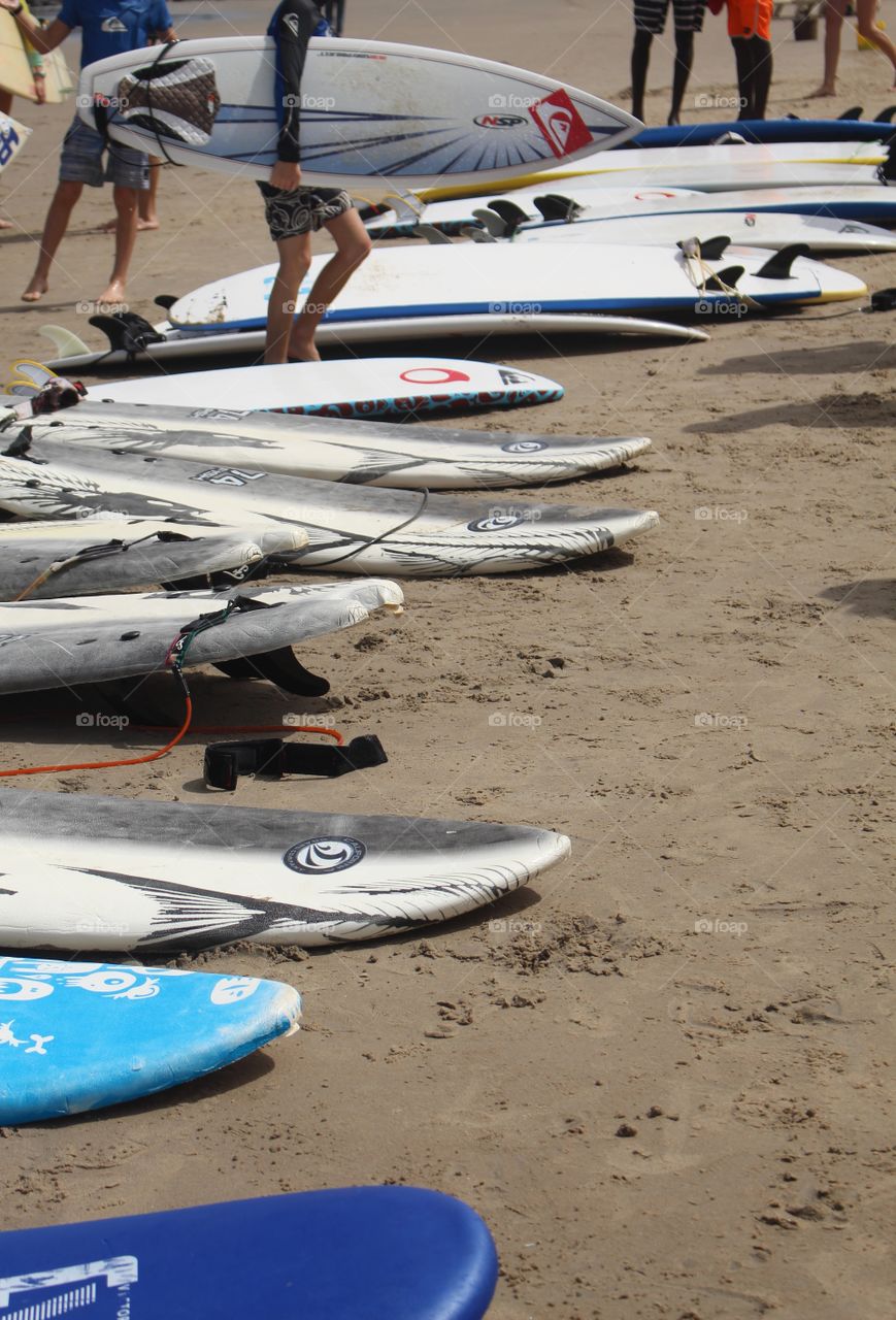 Boards lined up on the beach before a surf lesson