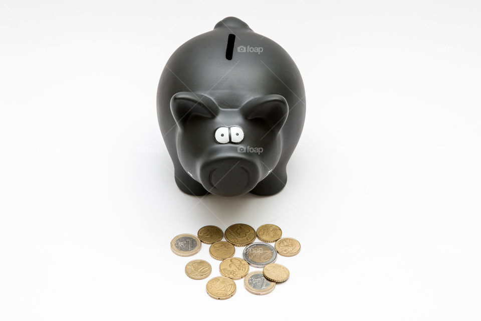 Black Piggy Bank With Coins, Isolated In White Backgound
