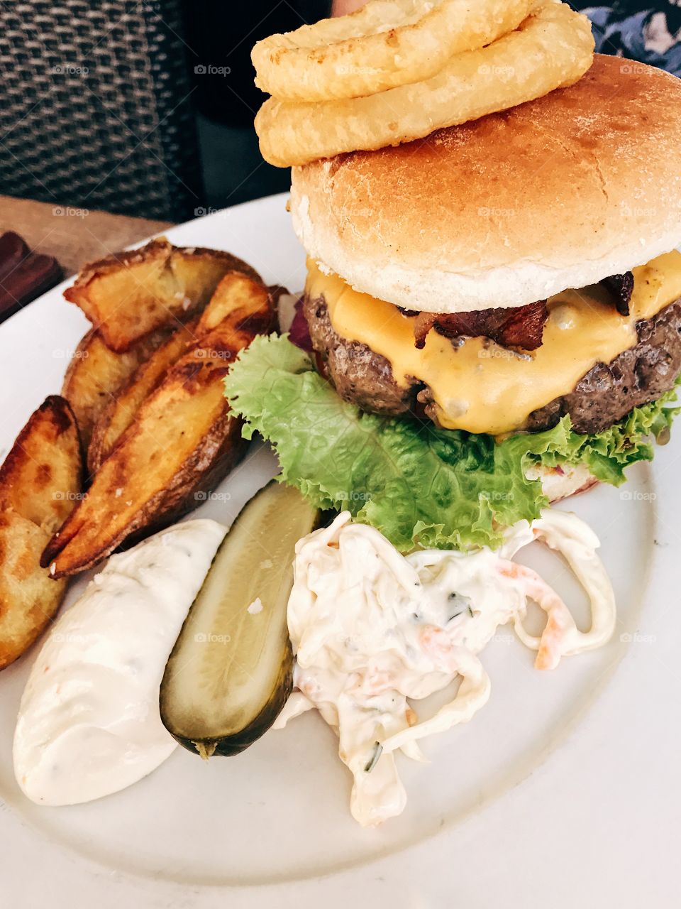 Hamburger with bacon, cheese, bread and pickles