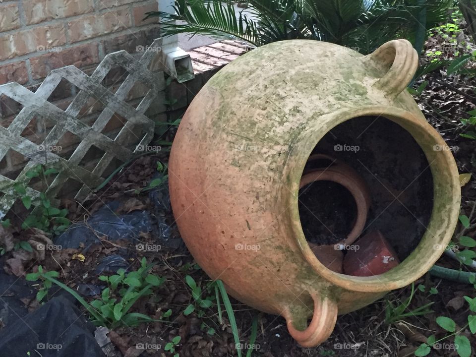 Old terra-cotta jug in a garden