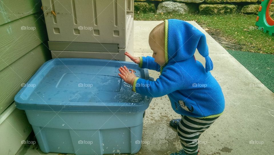 Side view of boy playing with water