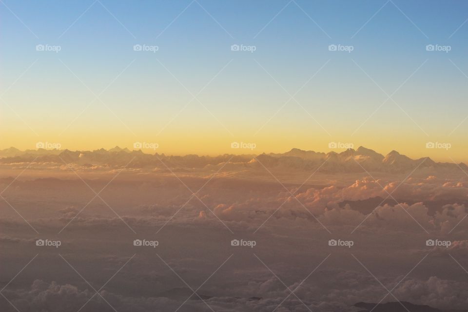 peaks of the great Himalayas immerging from the clouds above 30000 feets..