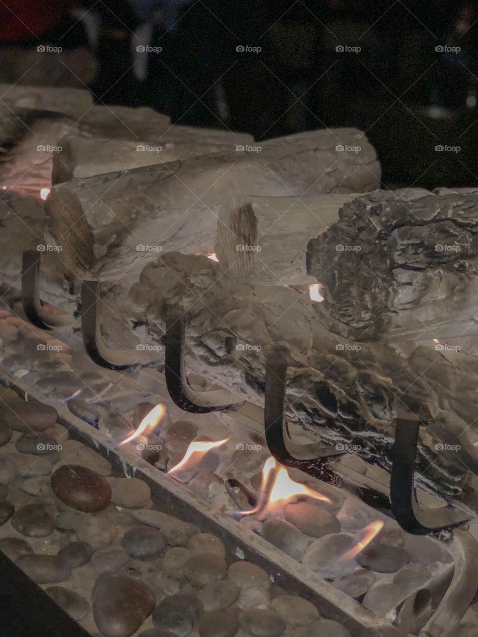 Fireplace lit with firewoods and stones