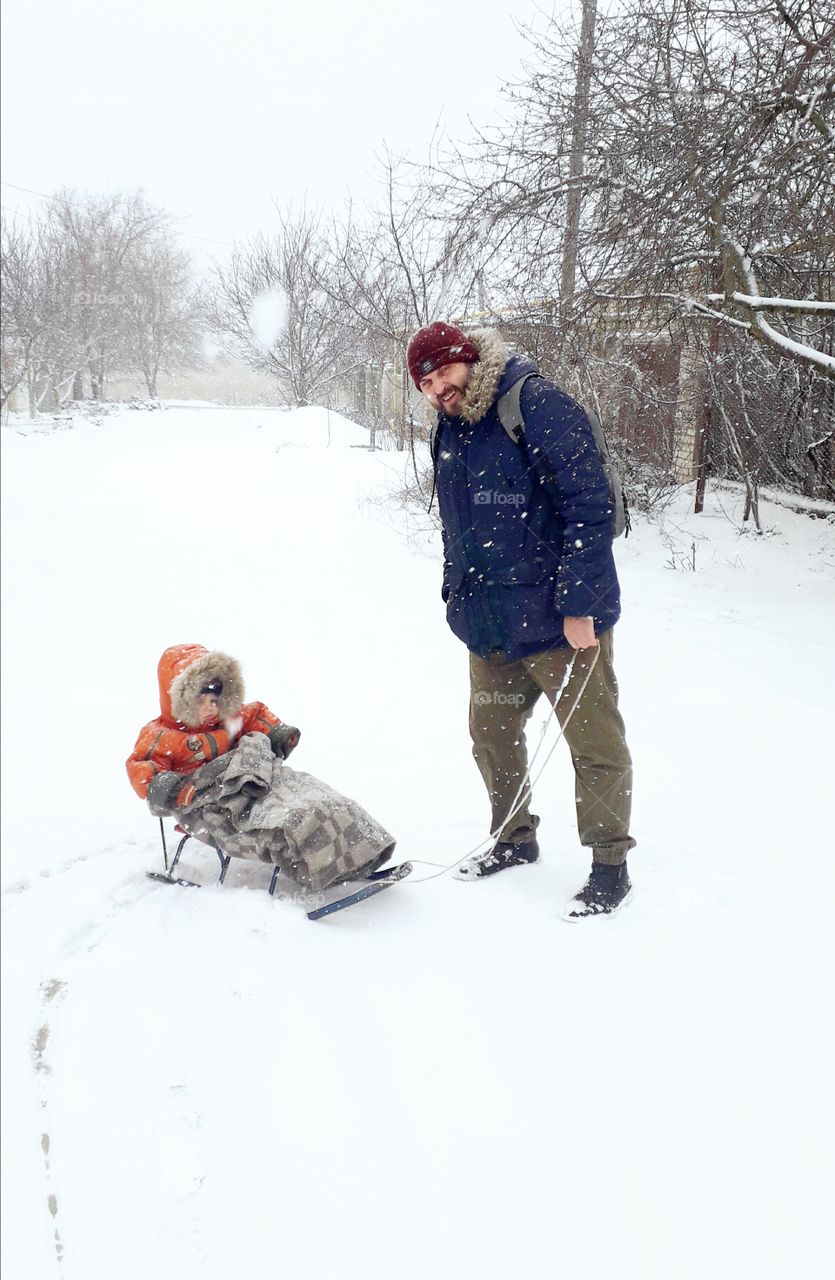 dad with kid in the snow