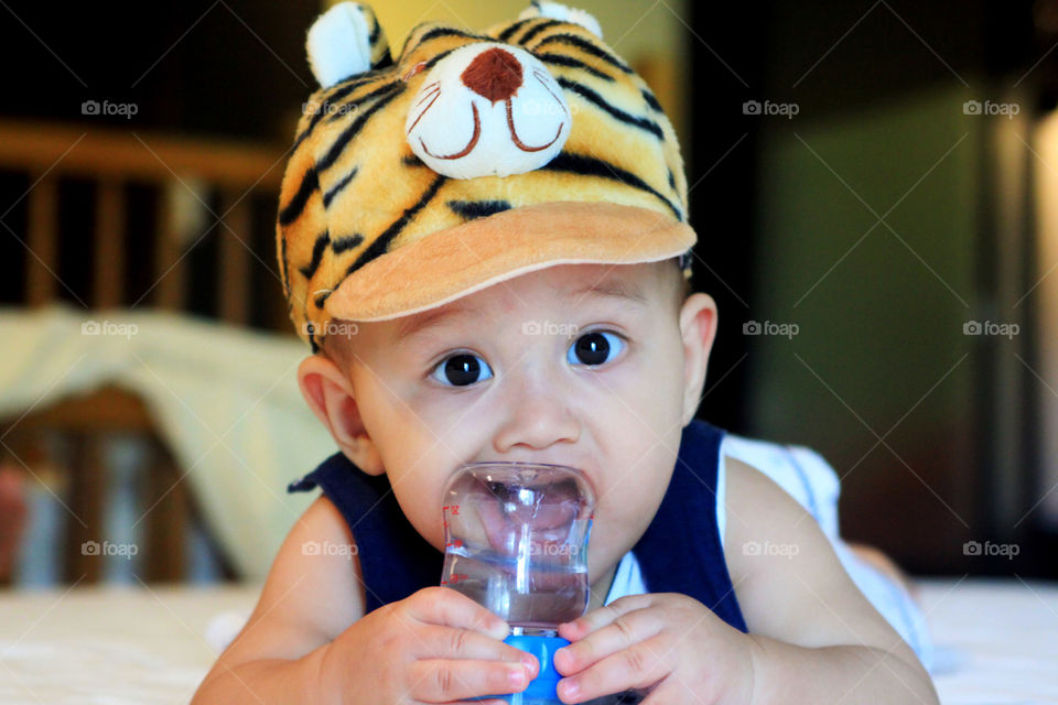 Lovely baby. cute kid holding a baby bottle