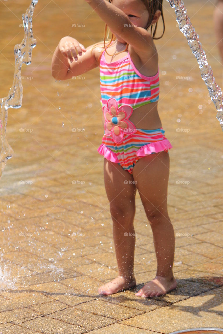 Little girl at play in the water