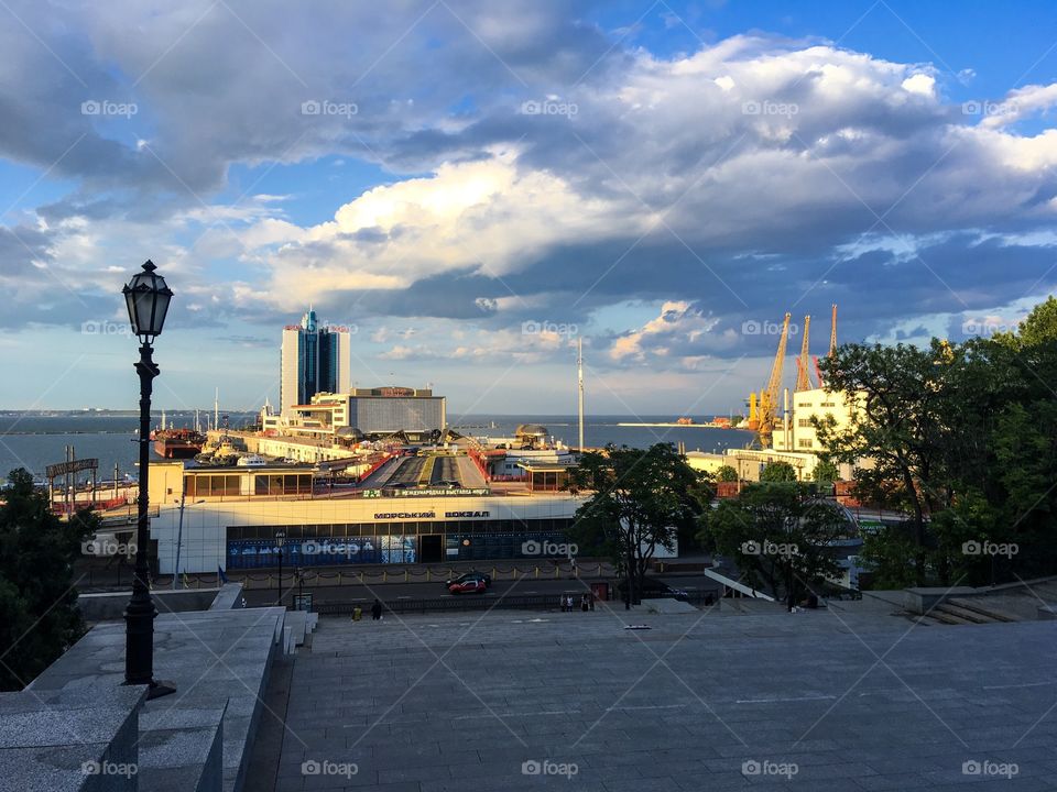 The Odessa sea port view from Potemkin stairs. City view. Sea landscape. Cloudy sky background. 