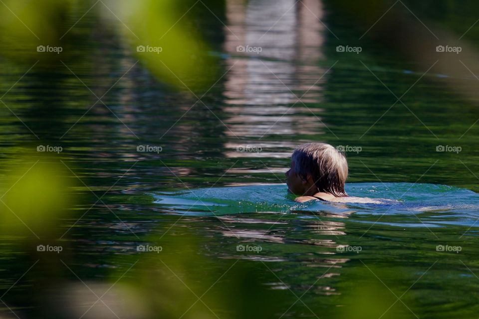 Woman Swimming In Lake