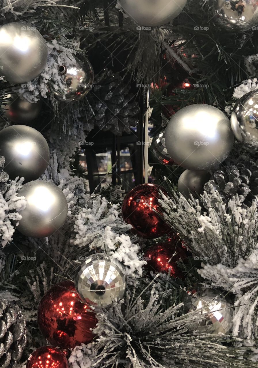 Green wreath with silver balls and red here and there and a sprinkle of snow. 