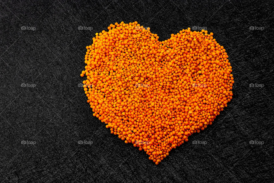 Heart made by orange lettuce - concept of healthy lifestyle.