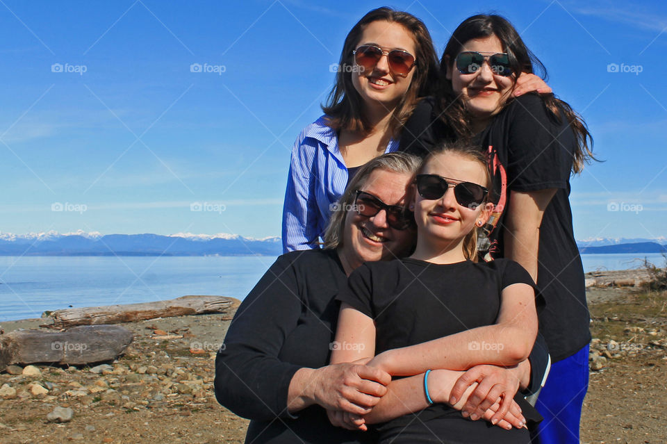 Nothing in this world makes me as happy as my family! This photo of me & my 3 beautiful daughters snuggling was taken at one of our favourite beaches on a beautiful sunny March afternoon. The background is beach, ocean & coastal mountains! ❤️