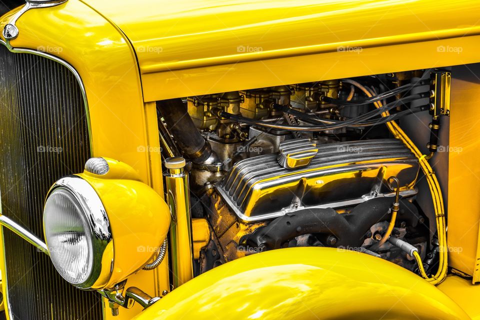 Classic car engine with bright yellow paint