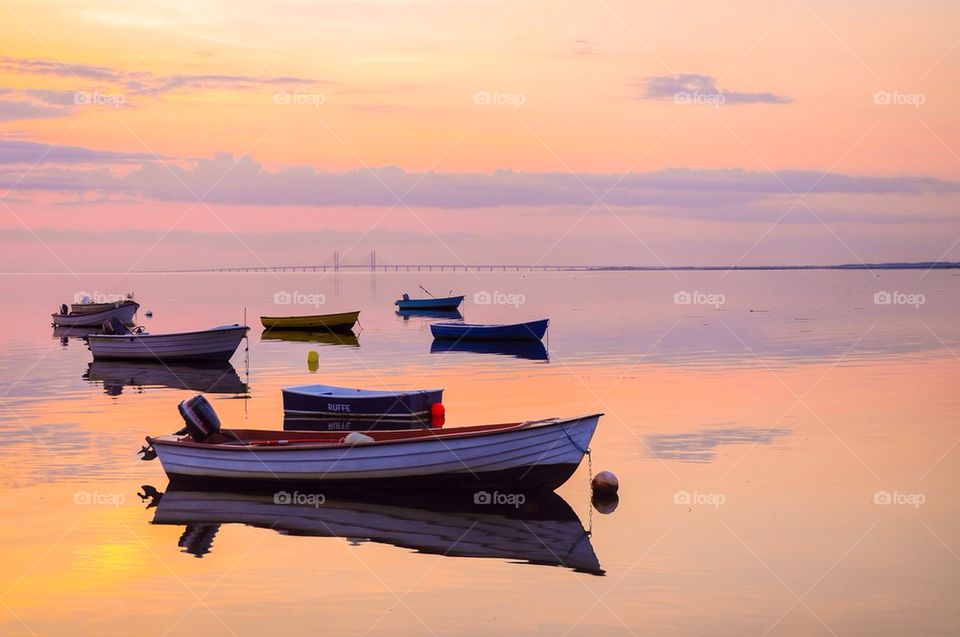 Boat in sea at sunset