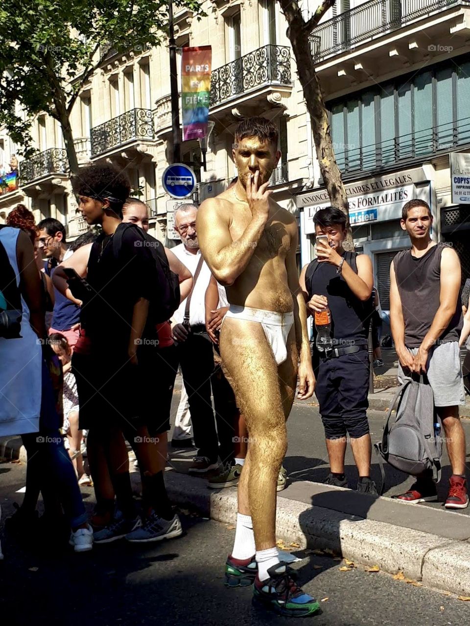 Man in underwear covered with golden paint. LGBT 