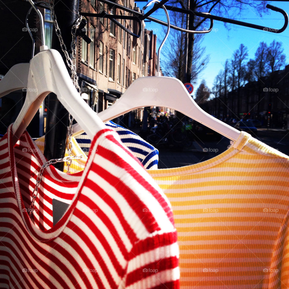 Striped t-shirts hanging at a market