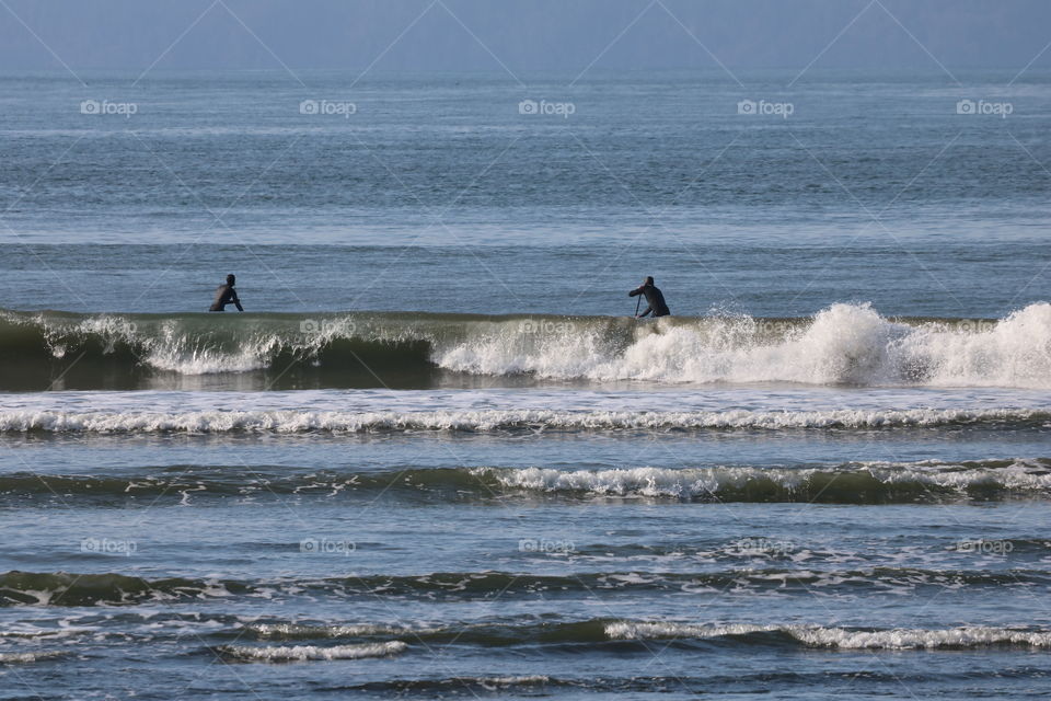 Surfing on big waves on a sunny spring day