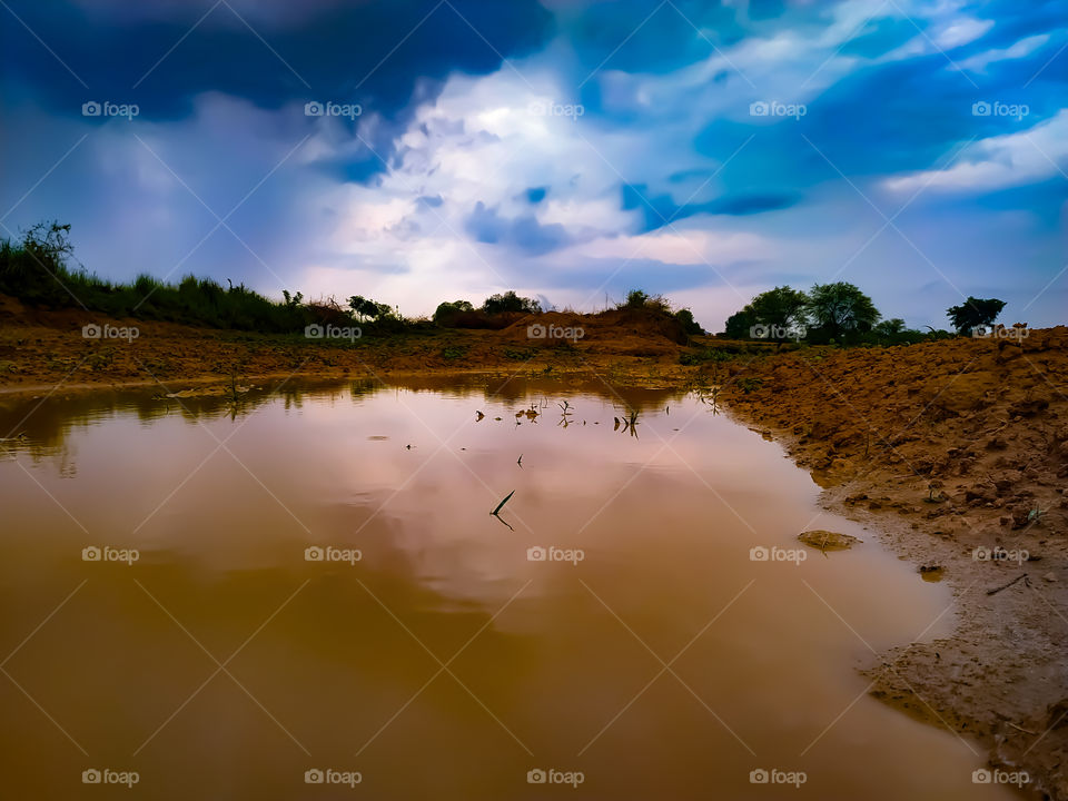 Rain water filled the field against the sky