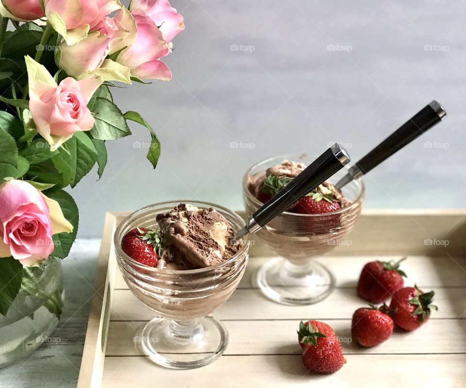 Ice cream on wooden tray with ripe berries