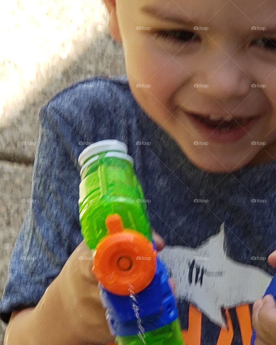 Smiles water guns and great big infectious belly giggles when he gets his target