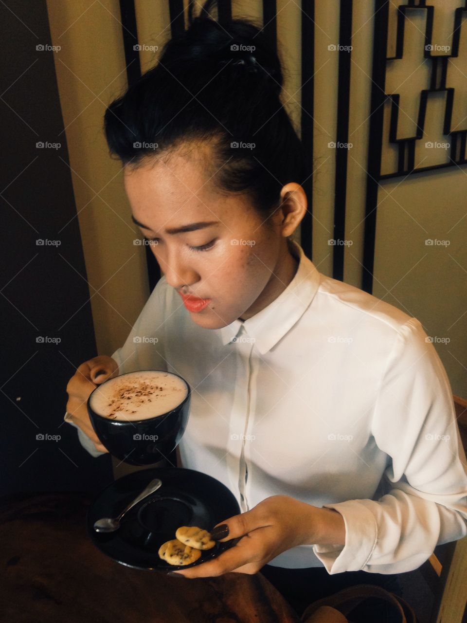 Asian woman drinking coffee