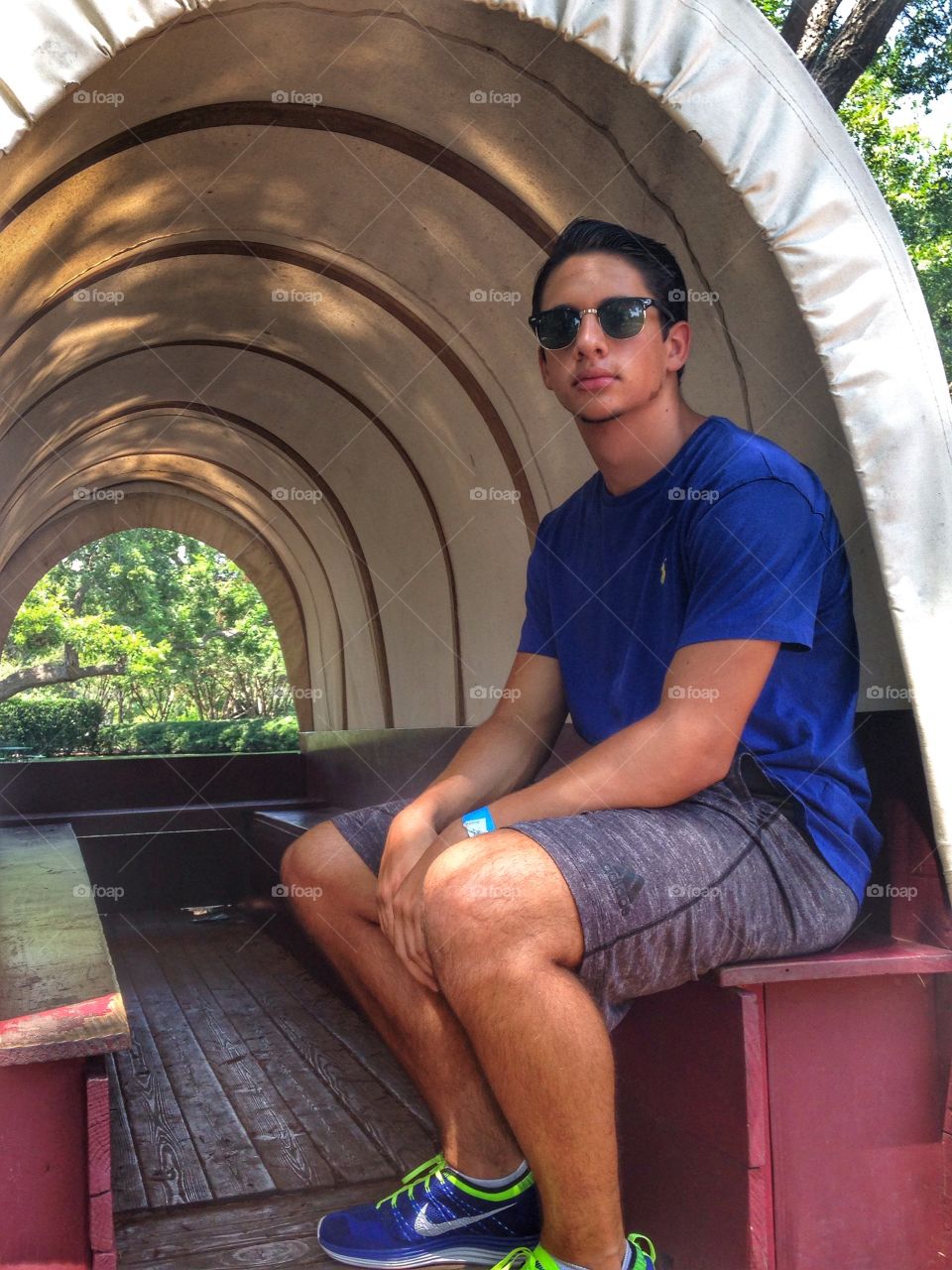 Wagon ride. Boy sitting in a covered wagon