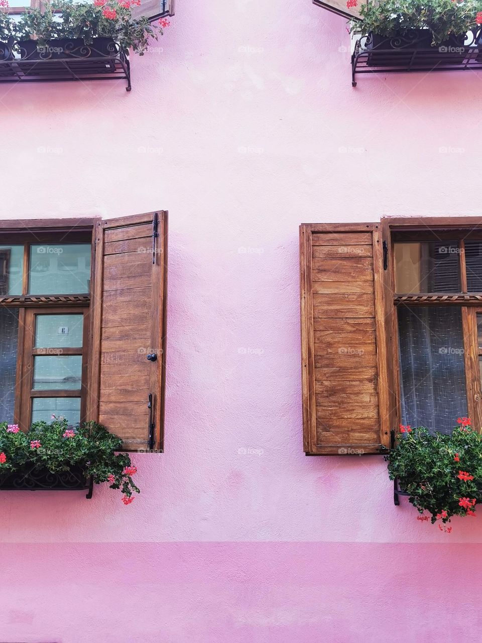 Romania. Old city of Sighisoara. Traditional colorful walls and windows with chatters.