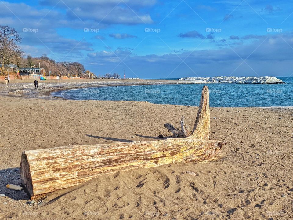 Scenic view of the snow covered rocks at the beautiful beach near Ontario lake,  Toronto. Blue sky. Winter landscape