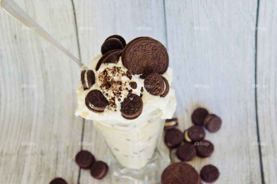 Oreo cookie milkshake with a wooden rustic white background