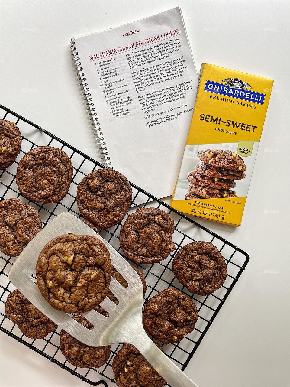 Making homemade cookies, baking Macadamia nut chocolate chunk cookies at home, making cookies with Ghirardelli’s chocolate, delicious cookies made from scratch, homemade cookies cooling on rack, placing cookies onto a cooling rack 